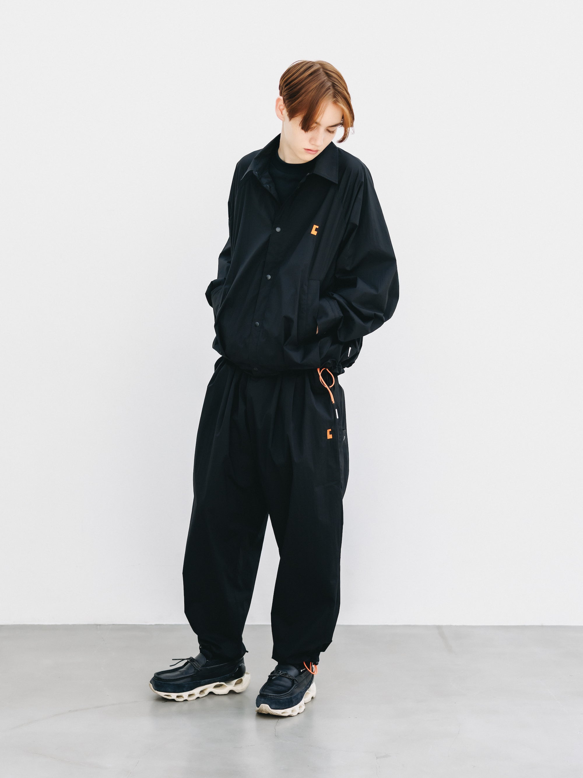 "C” CRISPY NYLON CITY UNIFORM WIDE TAPERED PANTS (BLACK×ORANGE)