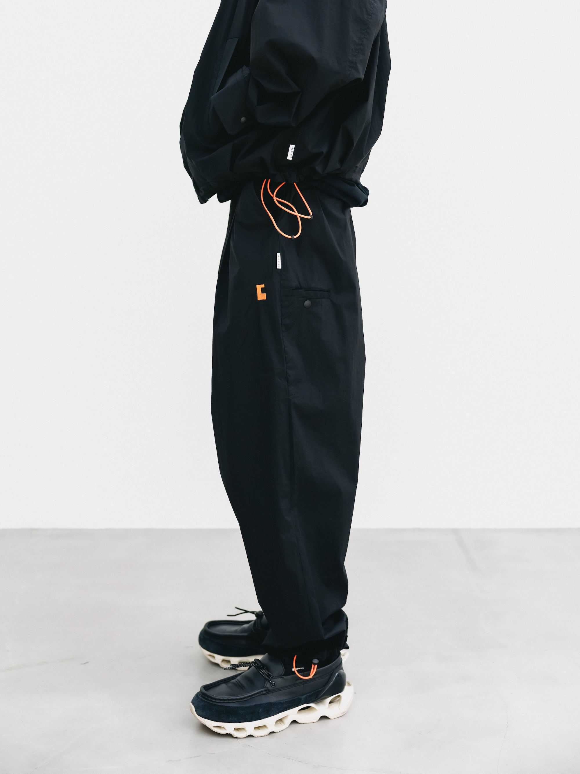 C” CRISPY NYLON CITY UNIFORM WIDE TAPERED PANTS (BLACK×ORANGE)